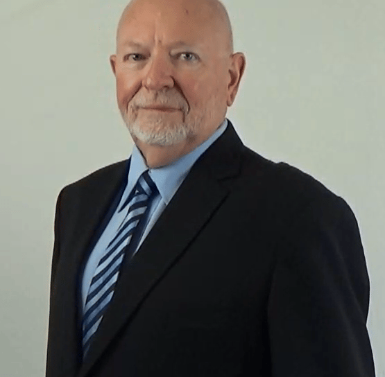 2025 David in a suit and tie with a blue shirt and striped tie