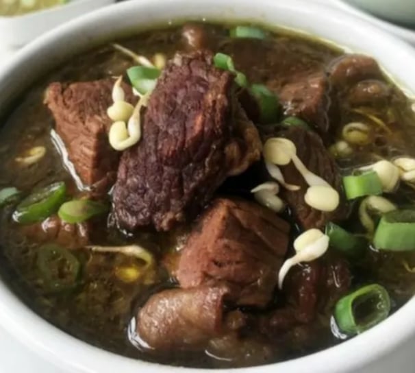 rawon linda a bowl of soup with meat and vegetables