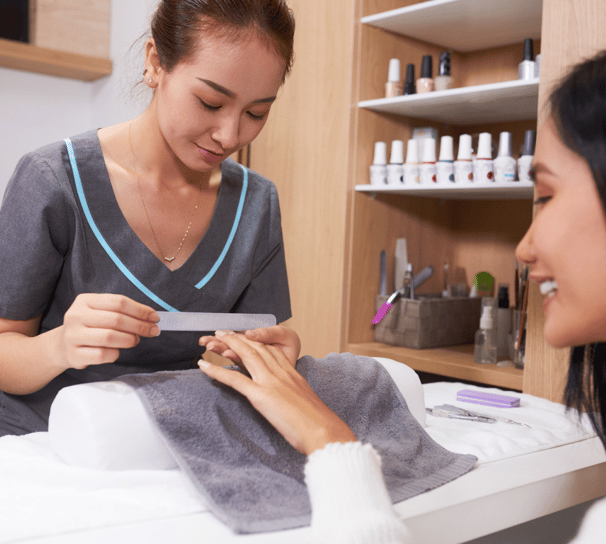 A customer is enjoying a nail treatment session at a professional nail salon