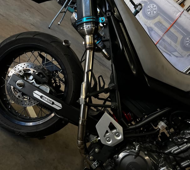 a motorcycle parked in a garage with a motorcycle
