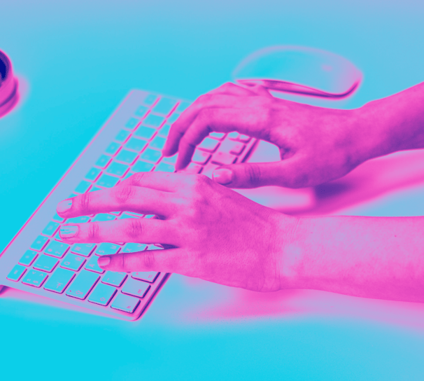 a person's hands typing on a keyboard