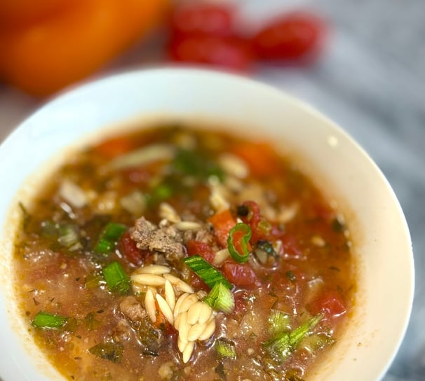 a bowl of soup with noodles and vegetables