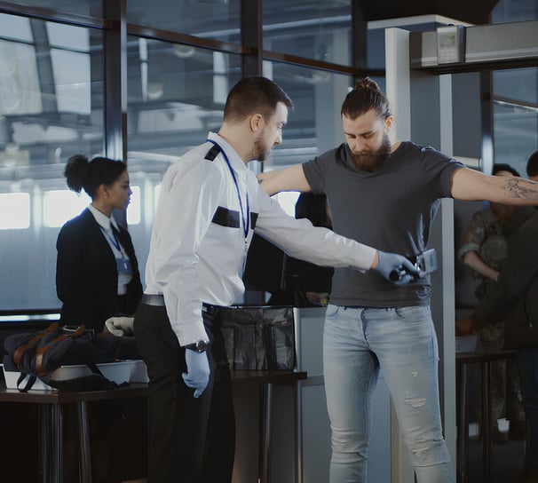 a man standing in front of a metal detector