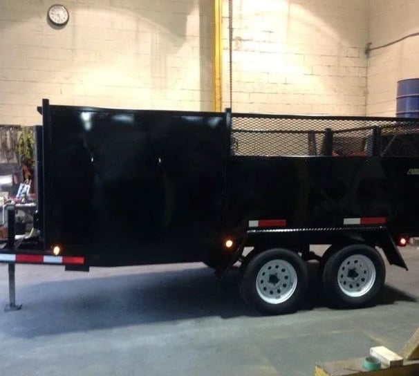 a black dumpster trailer with a black trailer