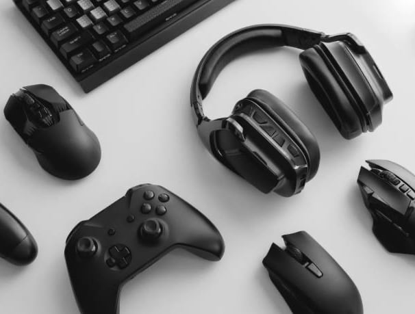 a keyboard, mouse, and headphones on a desk