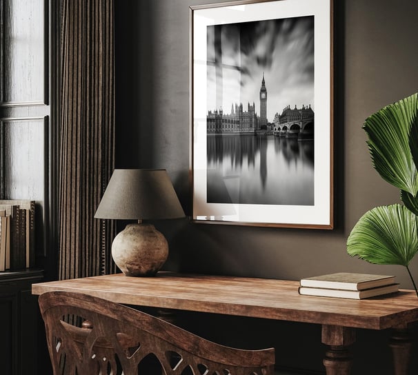 a desk with a lamp and a black and white photograph of big ben and part of the Palace of Westminster