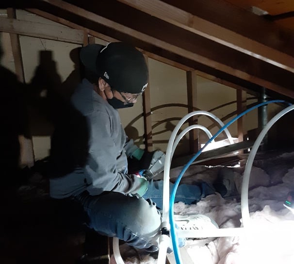 plumber in a ceiling with A-pex