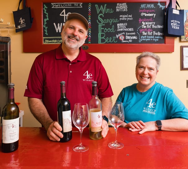 a man and woman standing in front of a bar