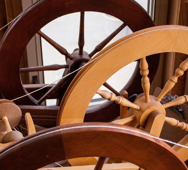 Spinning wheels lined up next to each other.