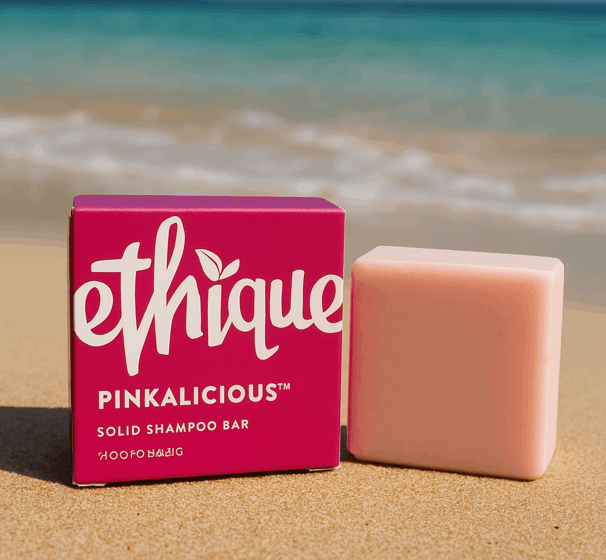 A shampoo bar from Ethique, the Pinkalicious version, sitting on the shore of a Thai beach