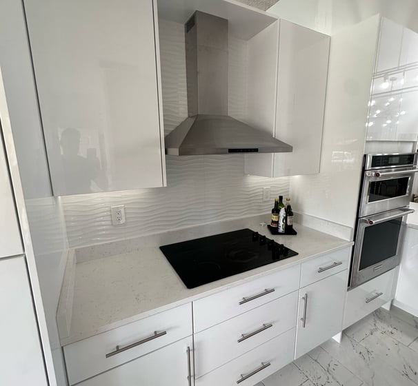 Before-and-after kitchen remodel showing wall removal and full layout redesign in Kissimmee resident
