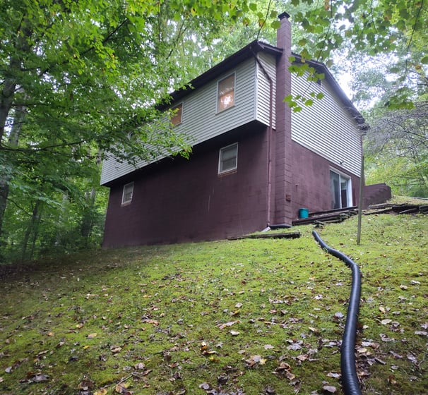 guys power wash & detailing after photo of back yard of mechanicsville md house and roof washing job