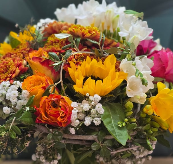 a bouquet of flowers in a vase on a table