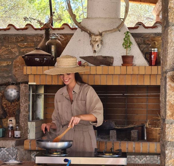 woman cooking traditional food in greek farmhouse