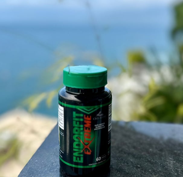 a bottle of green liquid sitting on a table
