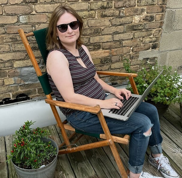 a woman sitting in a chair with a laptop