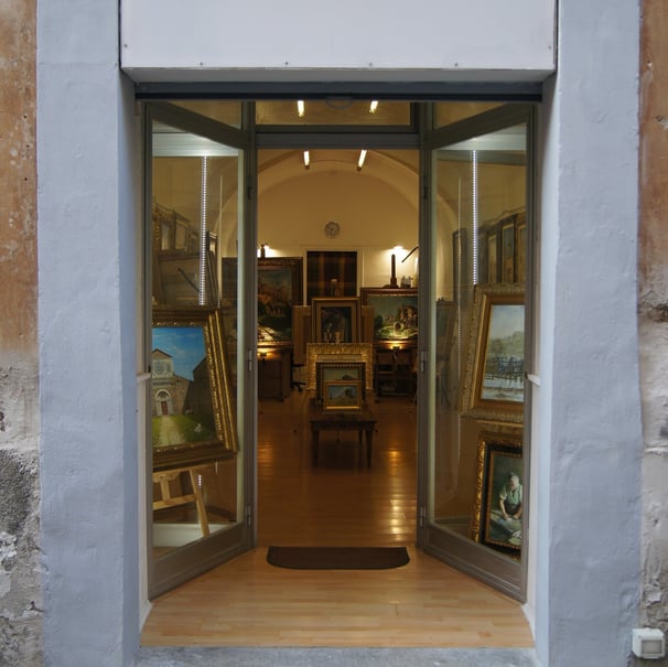 a doorway with a door open to a room with art work