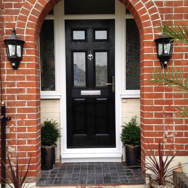 a black front door 2 panel 2 square glass with side panels