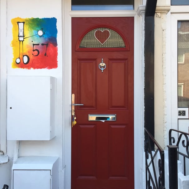 narrow red composite door with bespoke heart glass