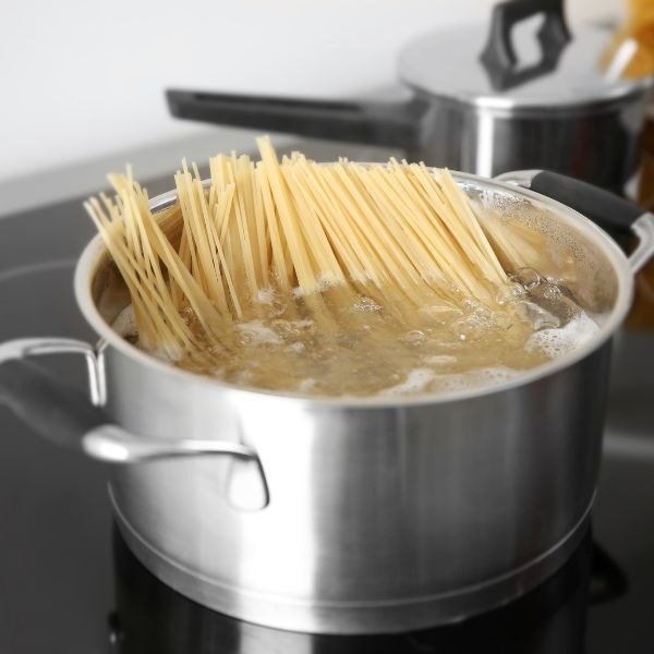 a pot boiling with spaghetti noodles
