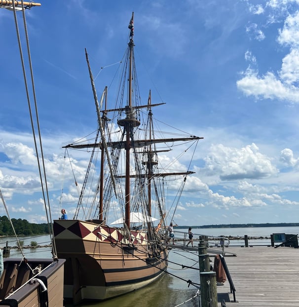 a boat docked at a dock with a boat in the water
