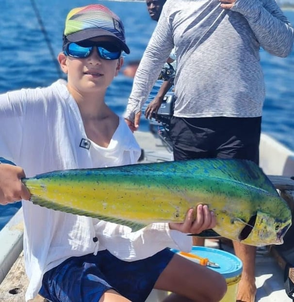 Young angler with a dorado fish on a Zanzibar Catamaran Fishing Charter