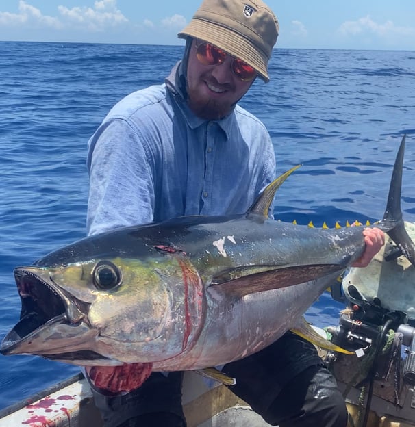 Angler holding a yellowfin tuna on a Catamaran Fishing Charter in Zanzibar