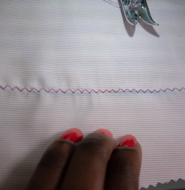 Zig zag stitches shown on pink fabric