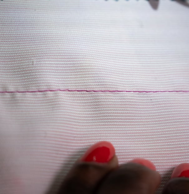 Basting stitch on pink fabric