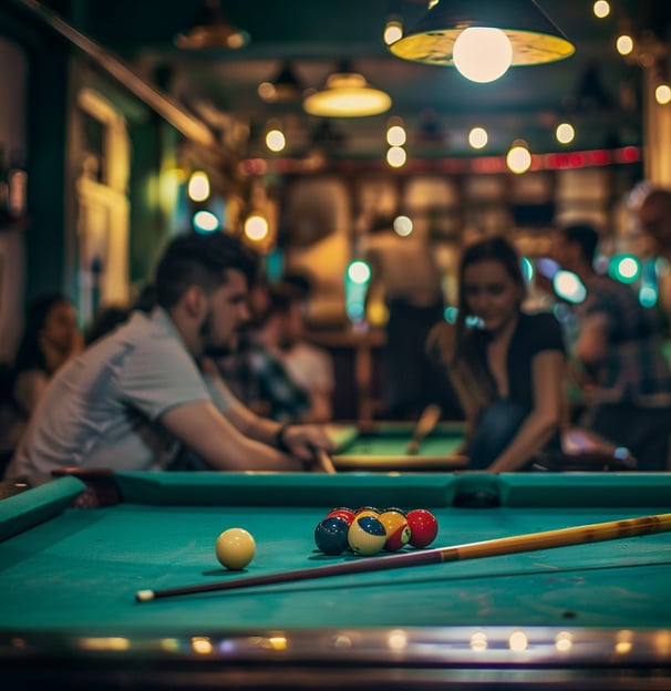 billiards table at bleachers & blayke's billiards pub with people playing in the background