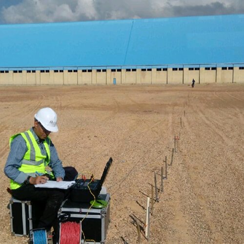 a man in a hard hat and a laptop computer