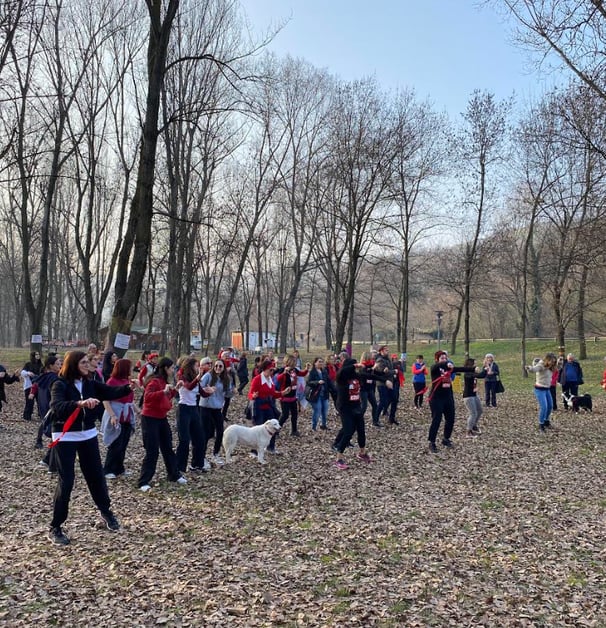 a group of people standing in a field with trees
