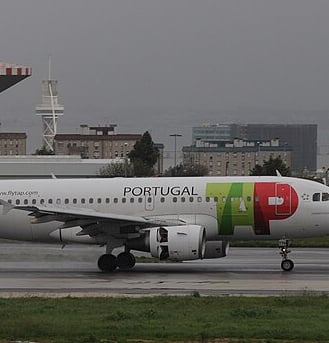 Portugal airlines- a plane with a colorful painted on it
