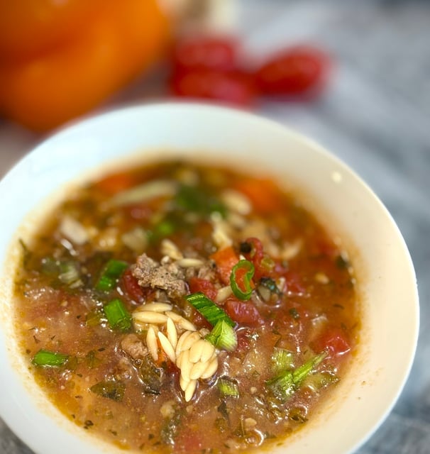 a bowl of soup with noodles and vegetables