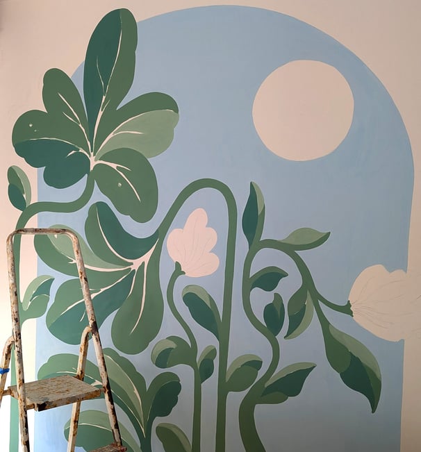 a ladder with a painting of a plant