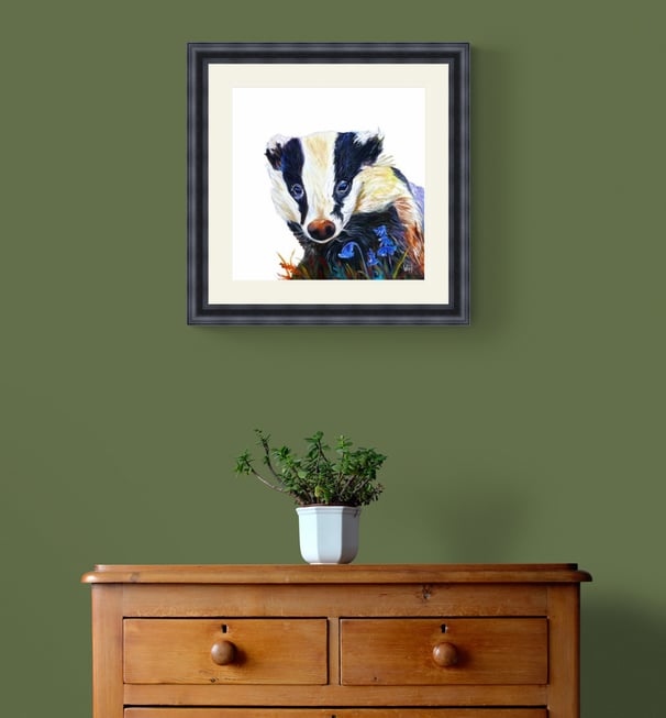 Badger painting in black frame on green wall