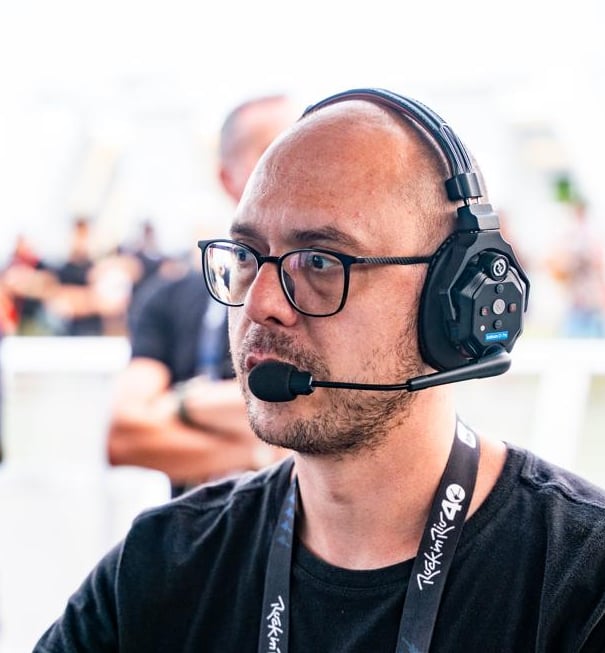 a man with a headset and a microphone in front of a microphone