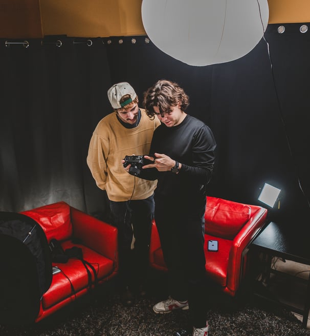 Two men setting up a podcast studio in Dallas, Texas.