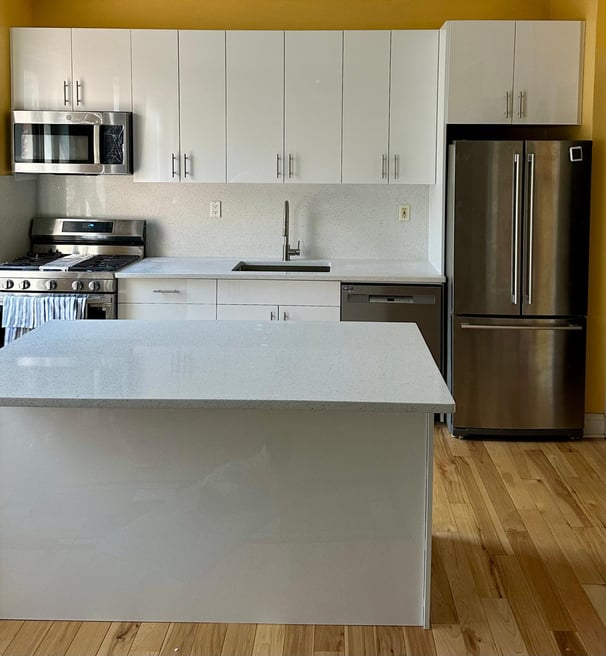 a kitchen with a stainless steel refrigerator and a refrigerator