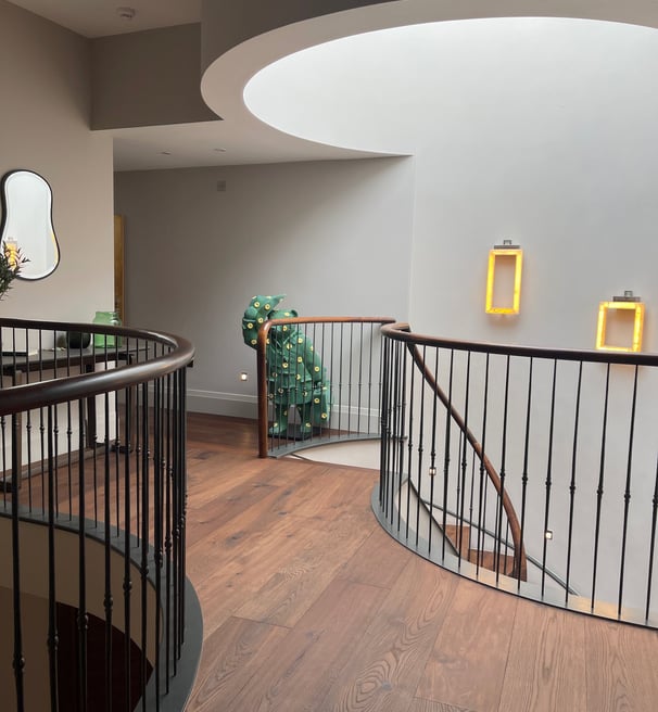 A brown oak plank floor in a curved hallway