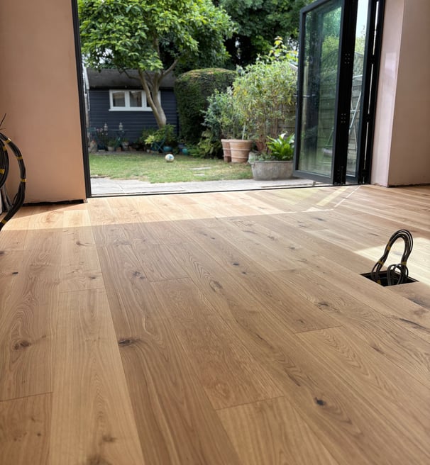 An oak plank floor in a kitchen extension with bifolding doors