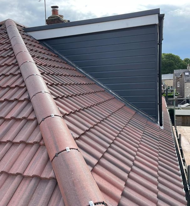 a new roof with a skylight and a skylight on top of a roof and dry ridge system London 