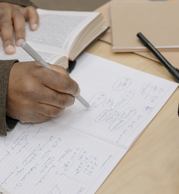 man writing notes