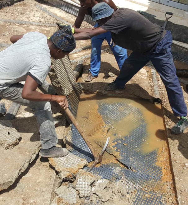 Removal of old waterproof membrane layer for advanced slab waterproofing project, Sandton, Fredman Drive