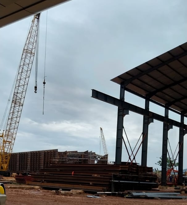 a crane is in the foreground of a construction site