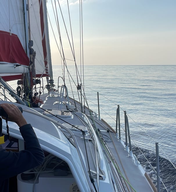 a man is taking a picture of a sailboat