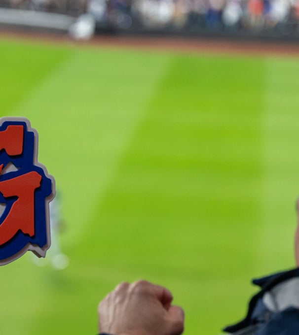 excited fans with a jose iglesias omg sign cheering the mets at citifield during nlcs game 5