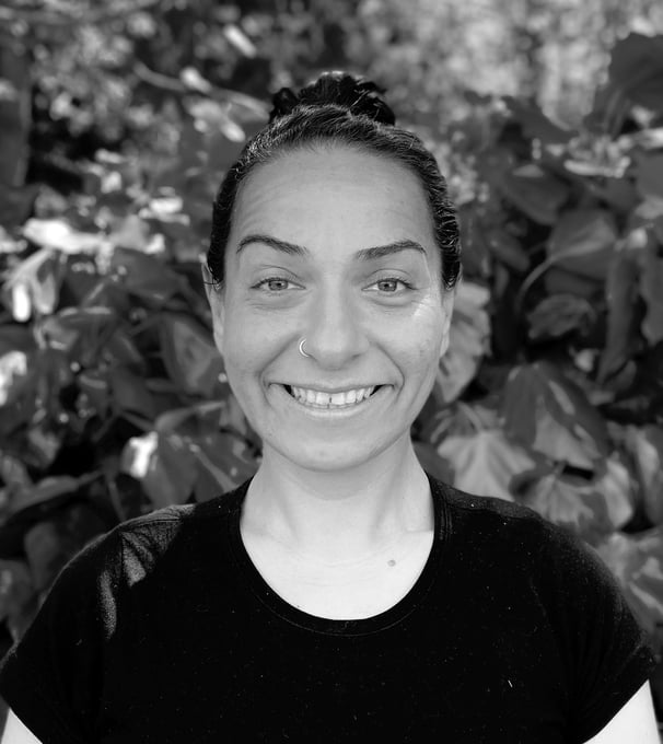Ebru Tütek, Tai Ji and Qi Gong instructor at WDP Türkiye, smiling outdoors in a forest setting.