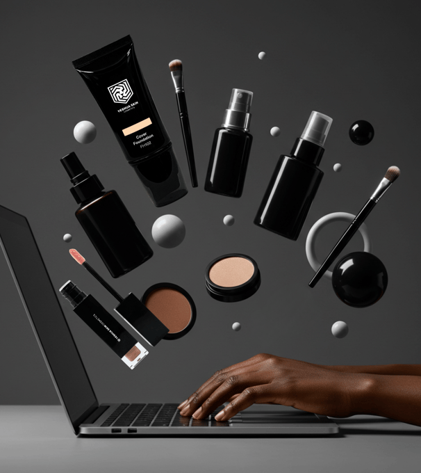 a person's hand is touching a laptop computer screen with floating cosmetics in the background