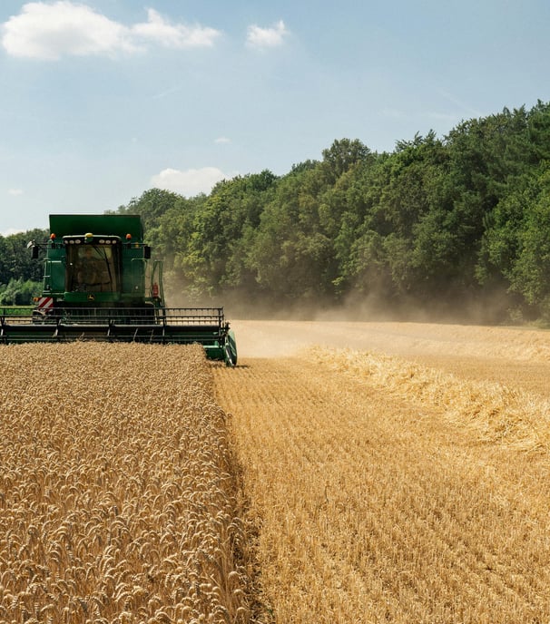 a combiner in a field with a tractor